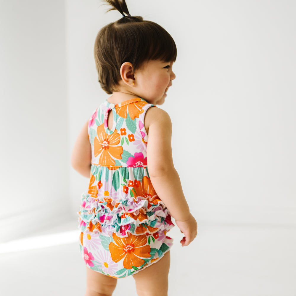 Back view image of a child wearing a Beachy Blooms bubble romper.