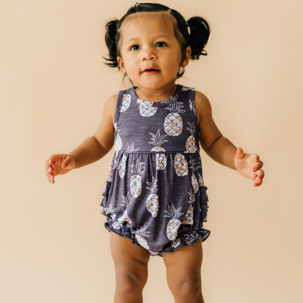 Child wearing a Sweet Paradise bubble romper