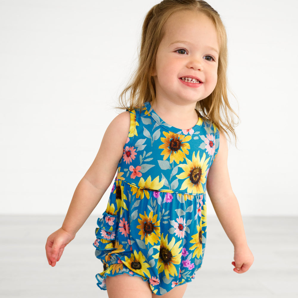 Close up image of a child wearing a Sunflower Fields Bubble Romper