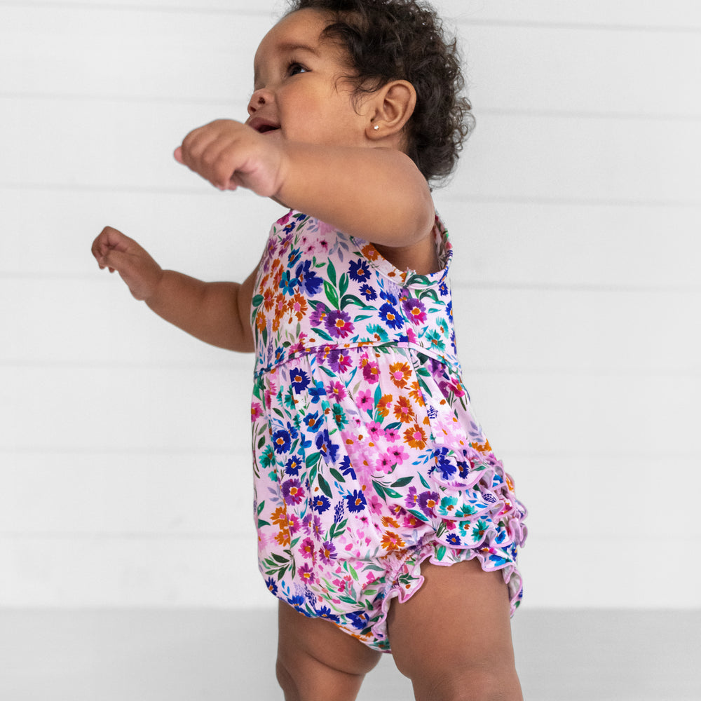 Image of a child wearing a Sweet Pea Floral Bubble Romper