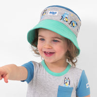 Child wearing a Bluey colorblock bucket hat and matching top