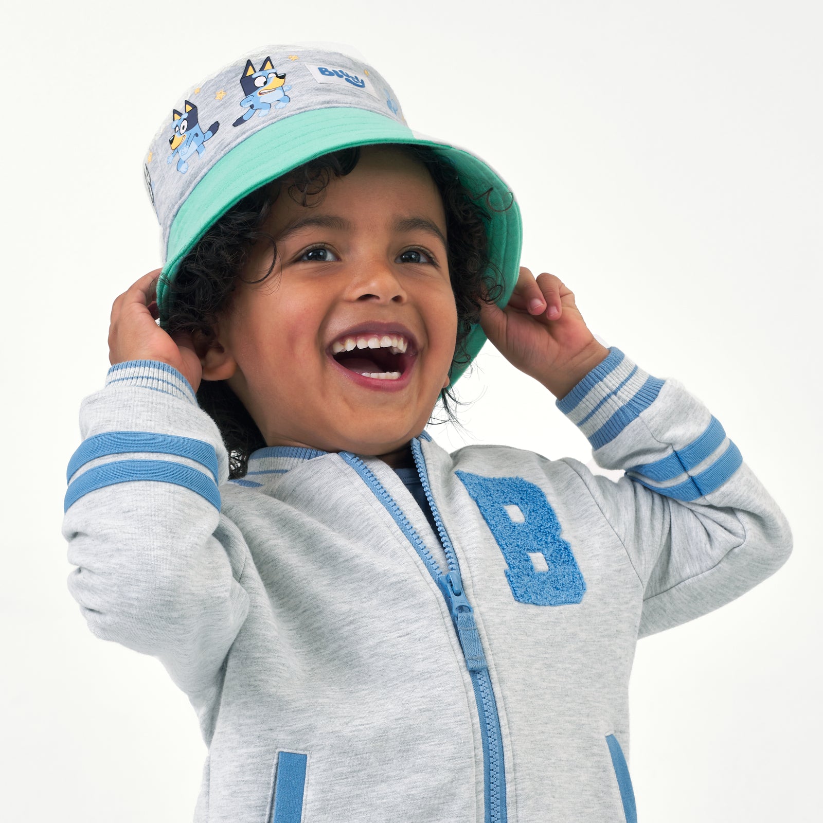 Child wearing a Bluey colorblock bucket hat and coordinating bomber jacket
