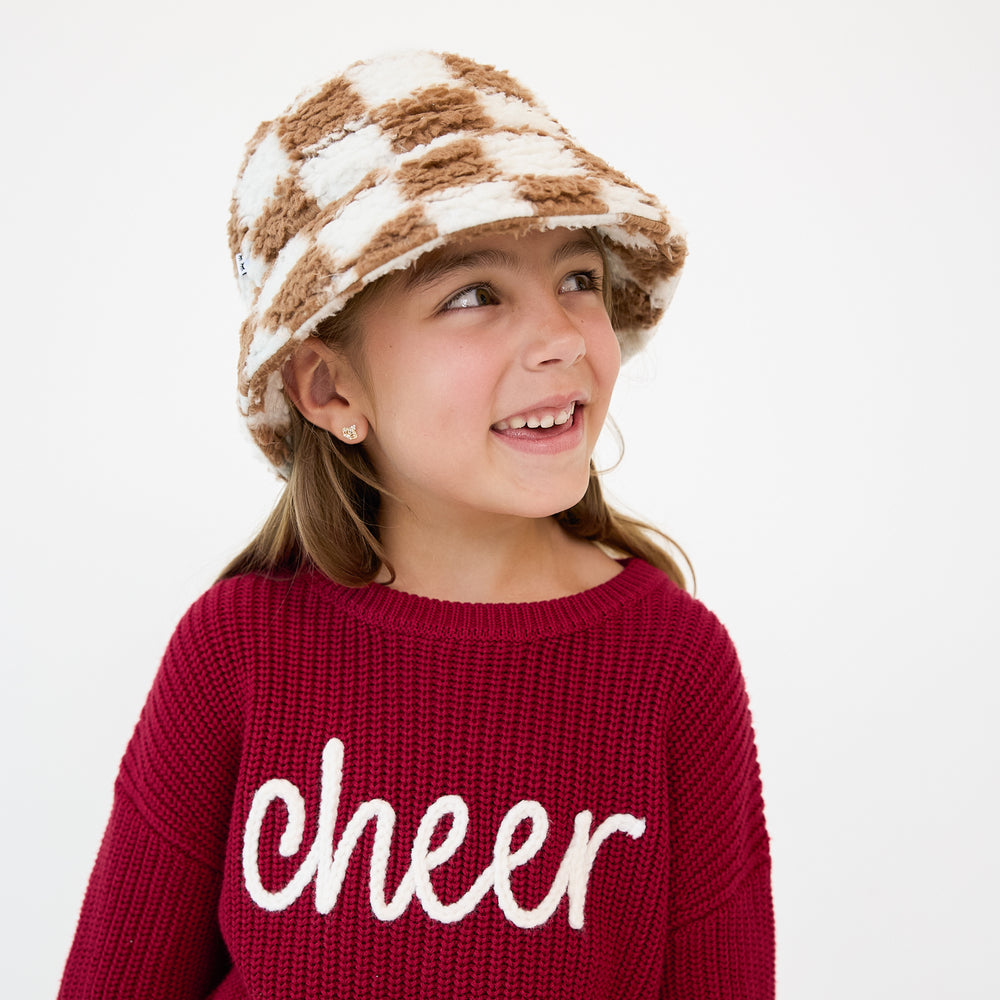 Alternate close up image of a child wearing a Caramel Checks Sherpa Bucket Hat