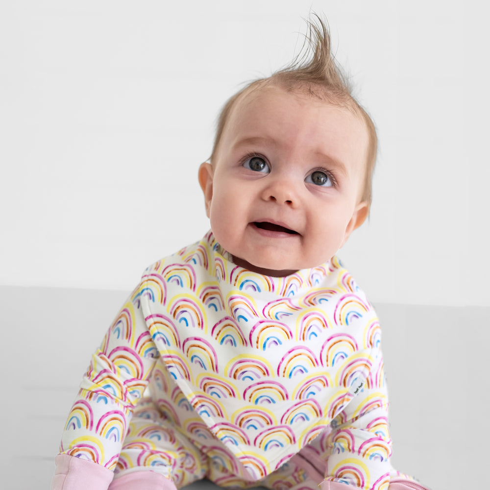 Close up image of a child wearing a Pastel Rainbows bandana bib