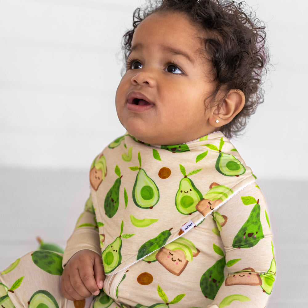 Close up image of a child wearing an Avocado Toast bandana bib