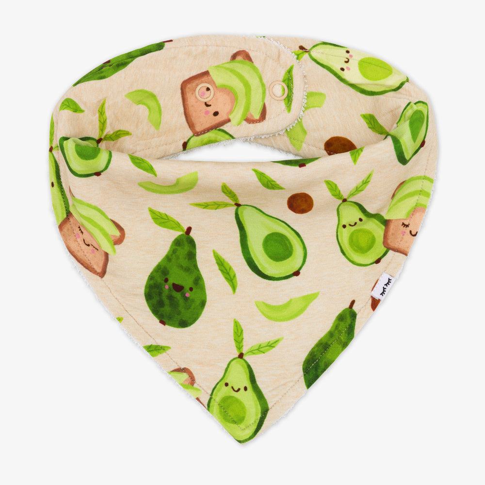 Flat lay image of a Avocado Toast bandana bib