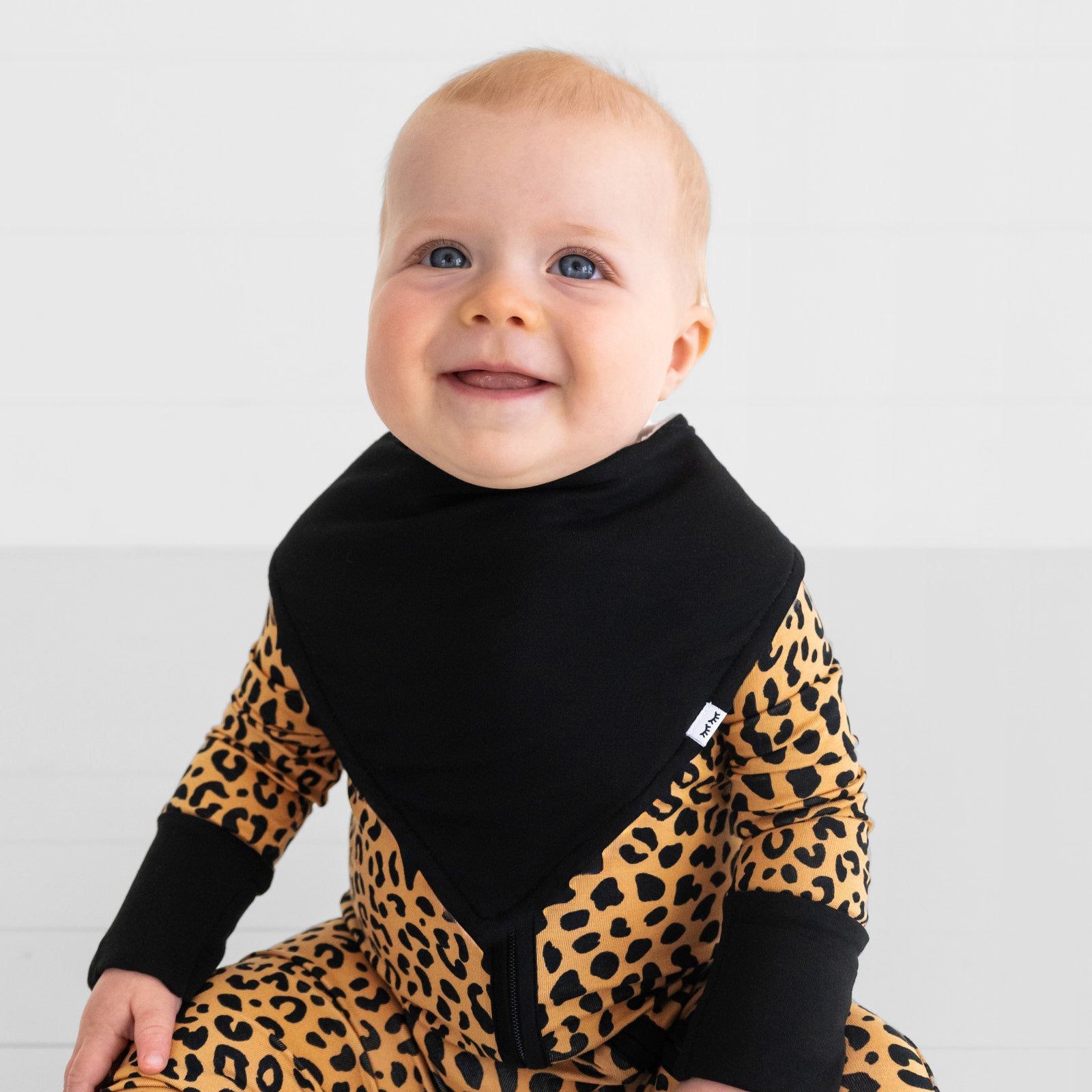 Alternate image of a child wearing a black bandana over a classic leopard zippy