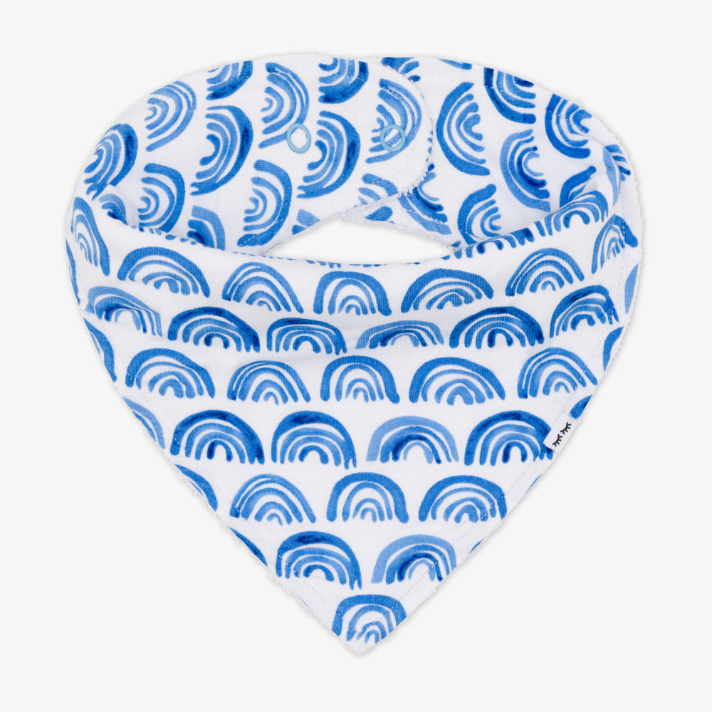 Flat lay image of a Blue Rainbows bandana bib