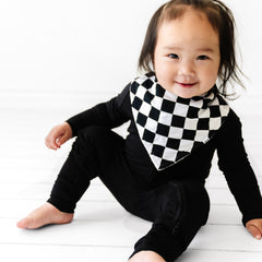 child wearing a Cool Checks bandana bib over a black zippy