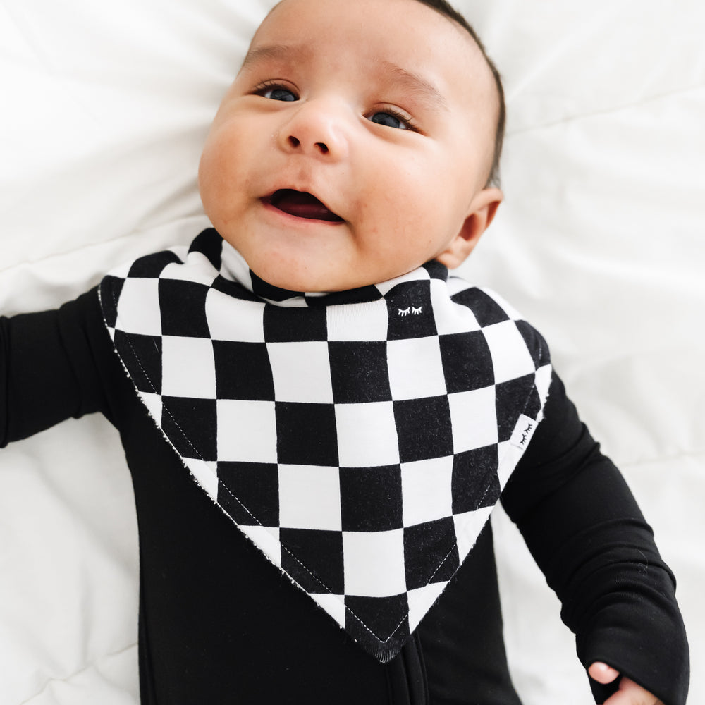 close up image of a child wearing a Cool Checks bandana bib over a black zippy