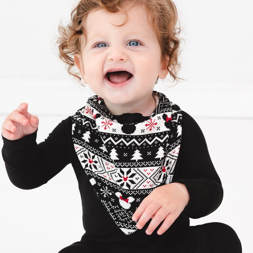 Child wearing Mickey Fair Isle bandana bib and black zippy