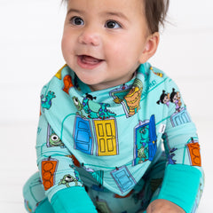 Close up image of baby wearing the Disney Monsters, Inc. Scream Team Bandana Bib and Disney Monsters, Inc. Scream Team Zippy