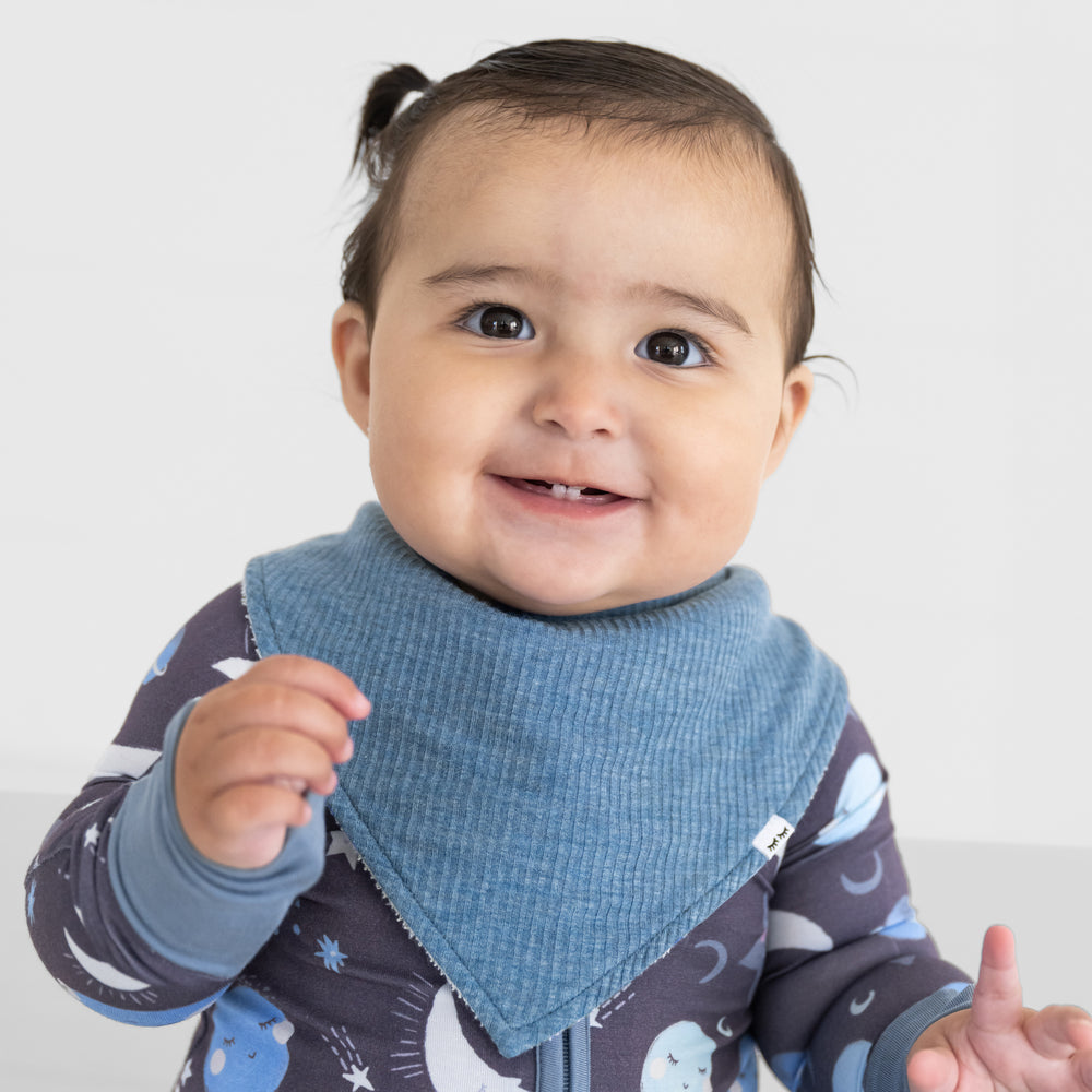 Close up image of a child wearing a Heather Blue ribbed bandana bib