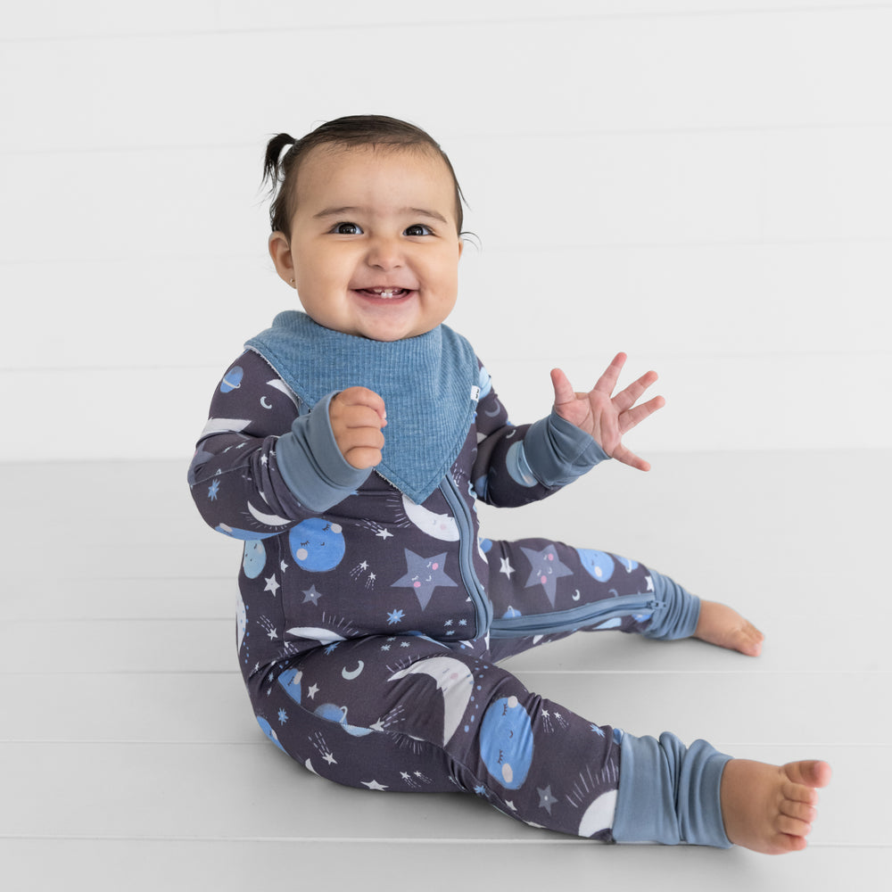 image of a child wearing a Heather Blue ribbed bandana bib over a Blue to the Moon Zippy