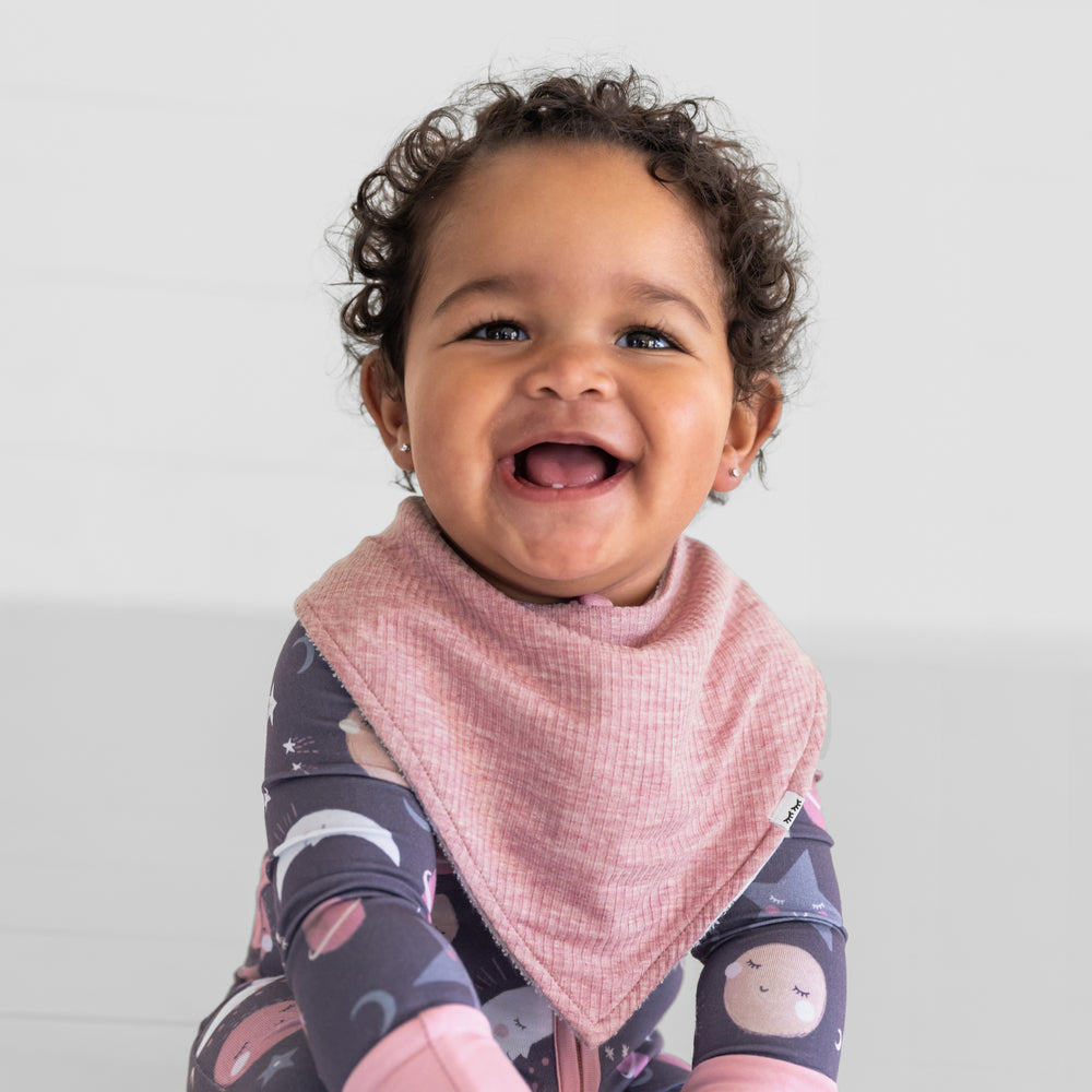 Close up image of a child wearing a Heather Mauve ribbed bandana bib