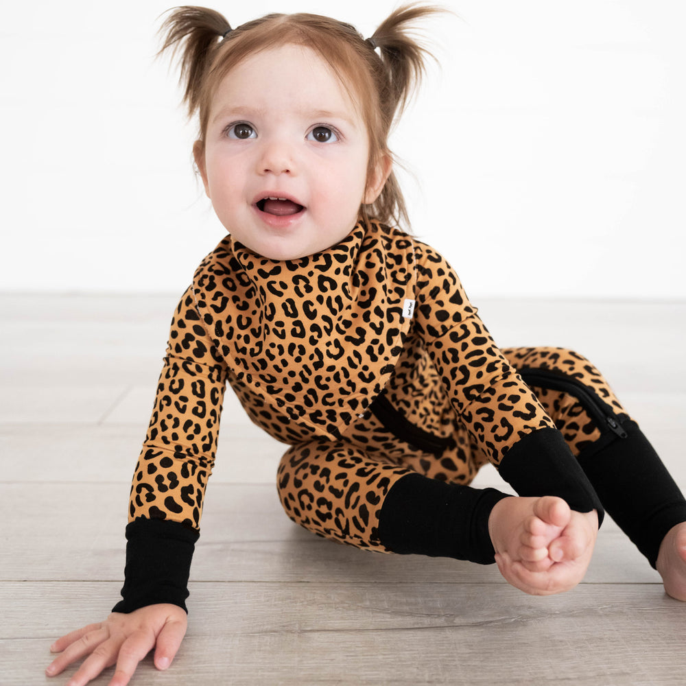 child wearing a Classic Leopard printed bib and matching zippy