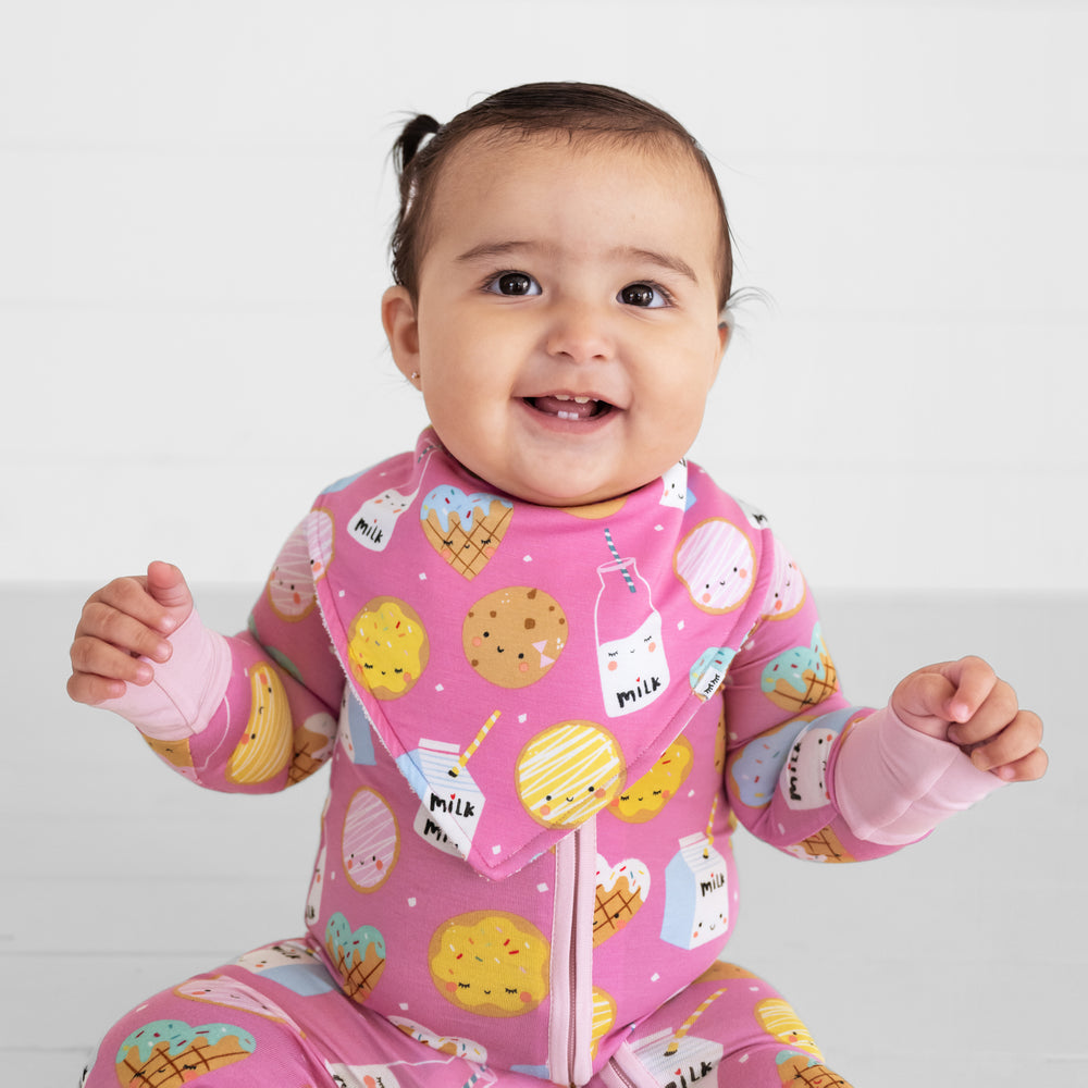 Close up image of a child wearing a Pink Cookies and Milk bandana bib