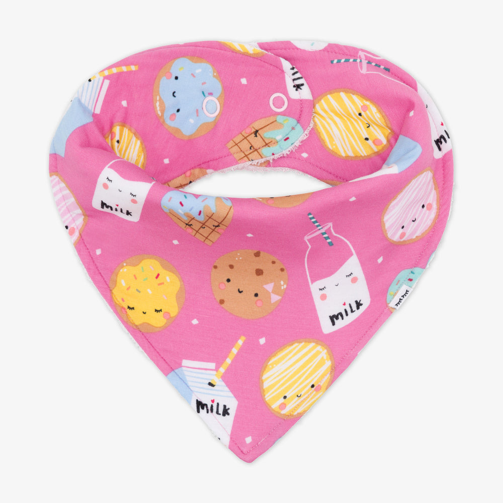 Flat lay image of a pink Cookies and Milk printed bandana bib