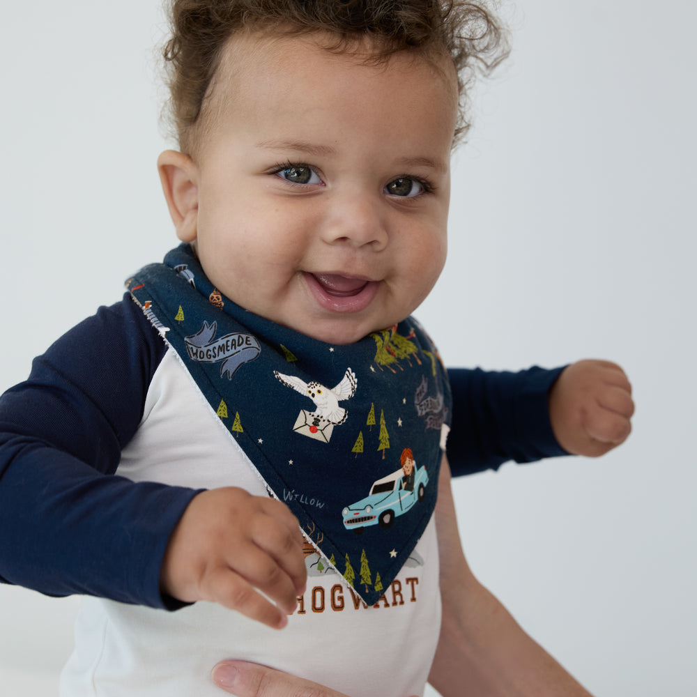 Close up image of a child wearing an Evening at Hogwarts bandana bib