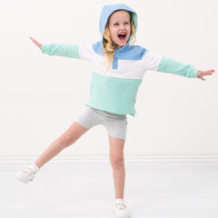 Child wearing Light Heather Gray bike shorts and coordinating pullover hoodie