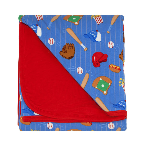 Flat lay image of a Blue All Stars large cloud blanket showing the solid red backing