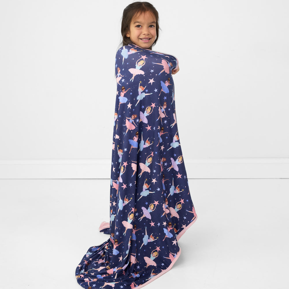 Image of a child wrapped up in a Twilight Ballet cloud blanket