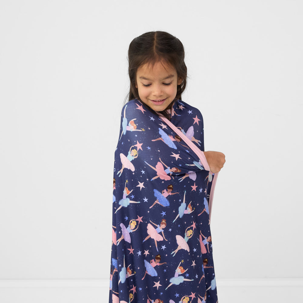 Close up image of a child wrapped in a Twilight Ballet cloud blanket