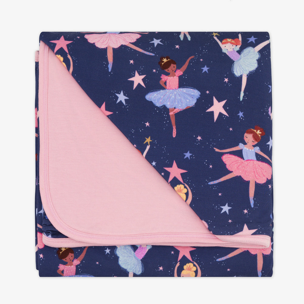 Flat lay image of a Twilight Ballet cloud blanket showing the solid pink backing