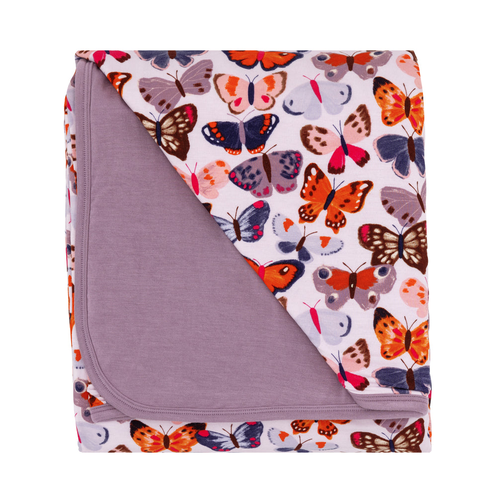 Flat lay image of a Butterfly Kisses large cloud blanket