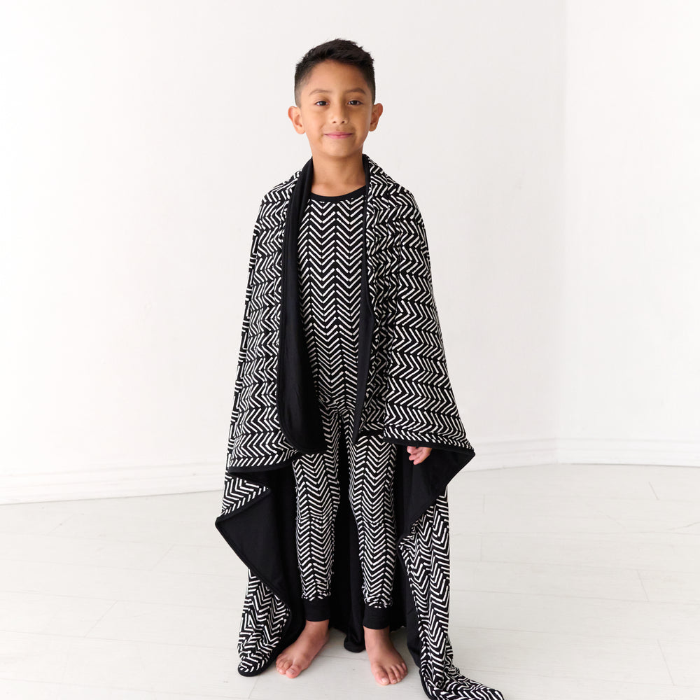 Child with a Monochrome Chevron large cloud blanket around their shoulders and wearing matching pajamas