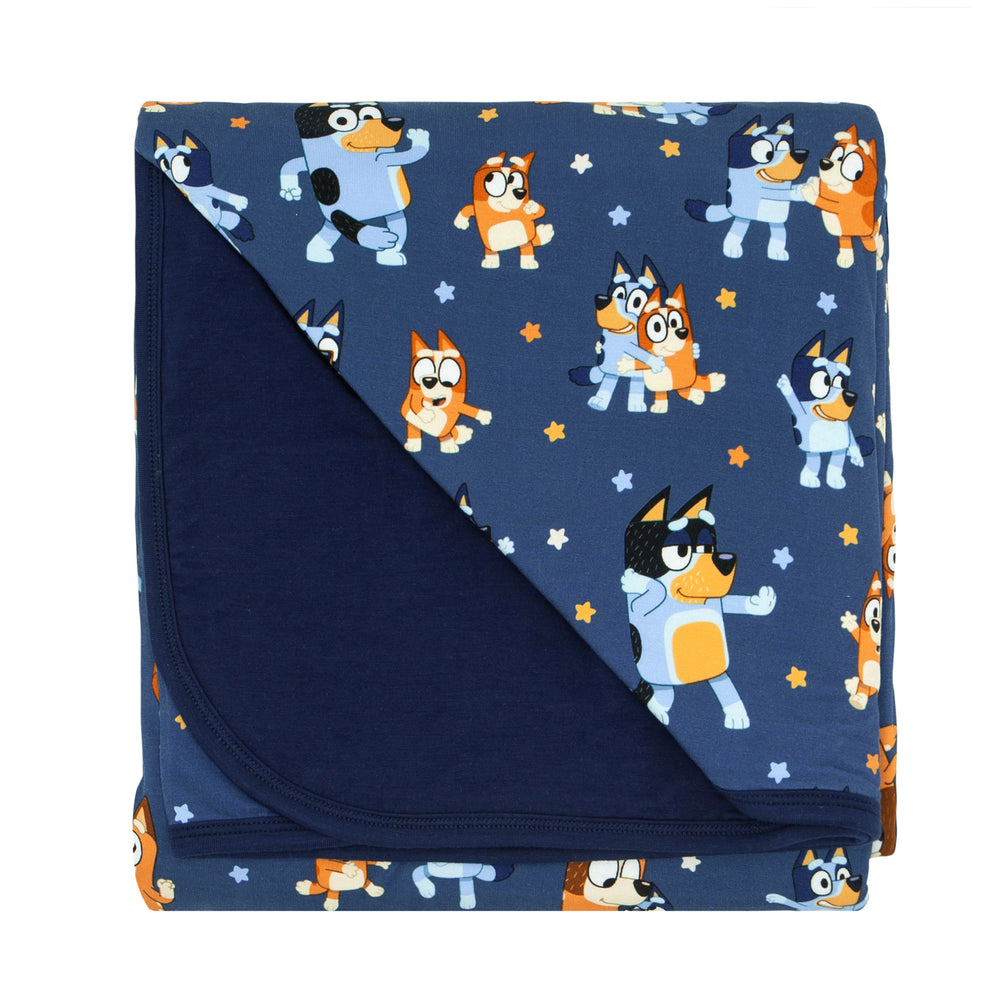 Flat lay image of a Bluey Dance Mode large cloud blanket showing the navy backing