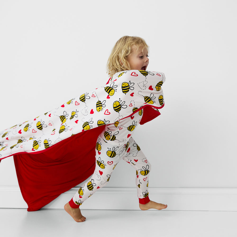 Child wearing Bee Mine pajamas with matching blanket.