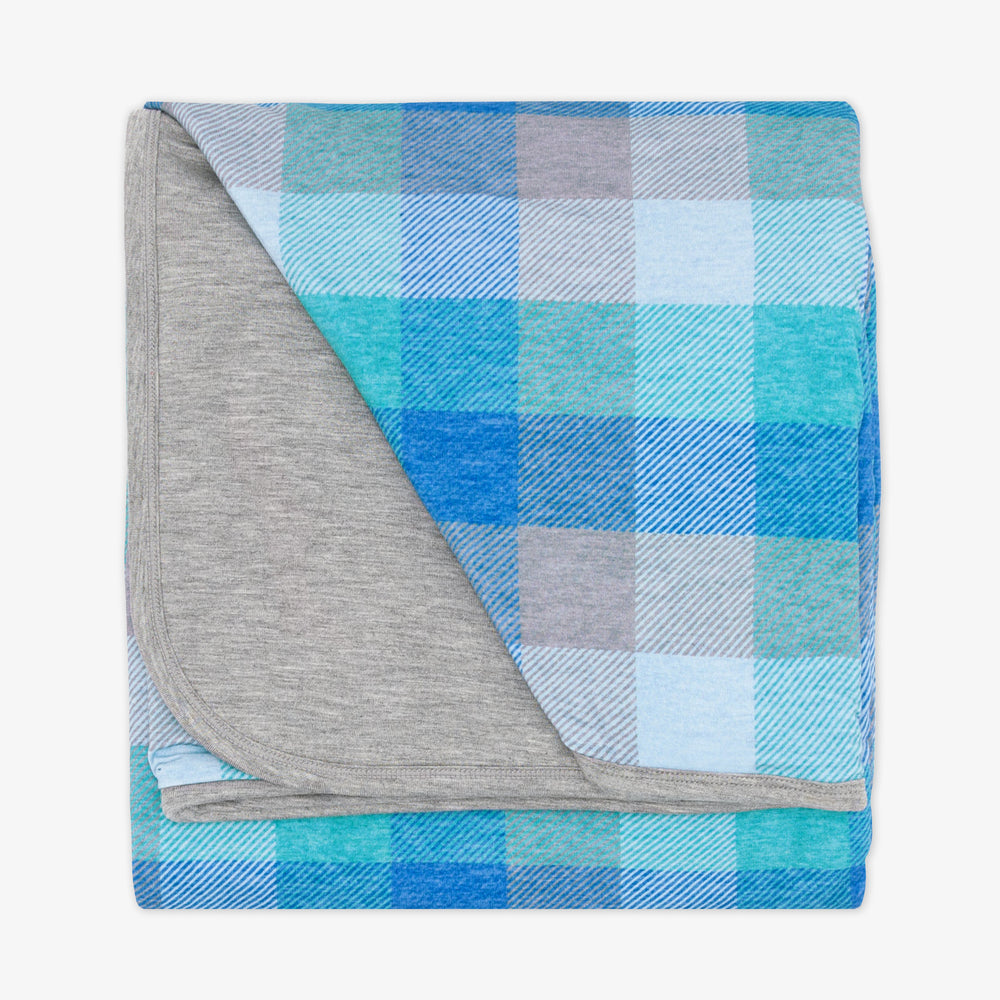 Flat lay image of an Arctic Plaid cloud blanket showing the heather gray backing