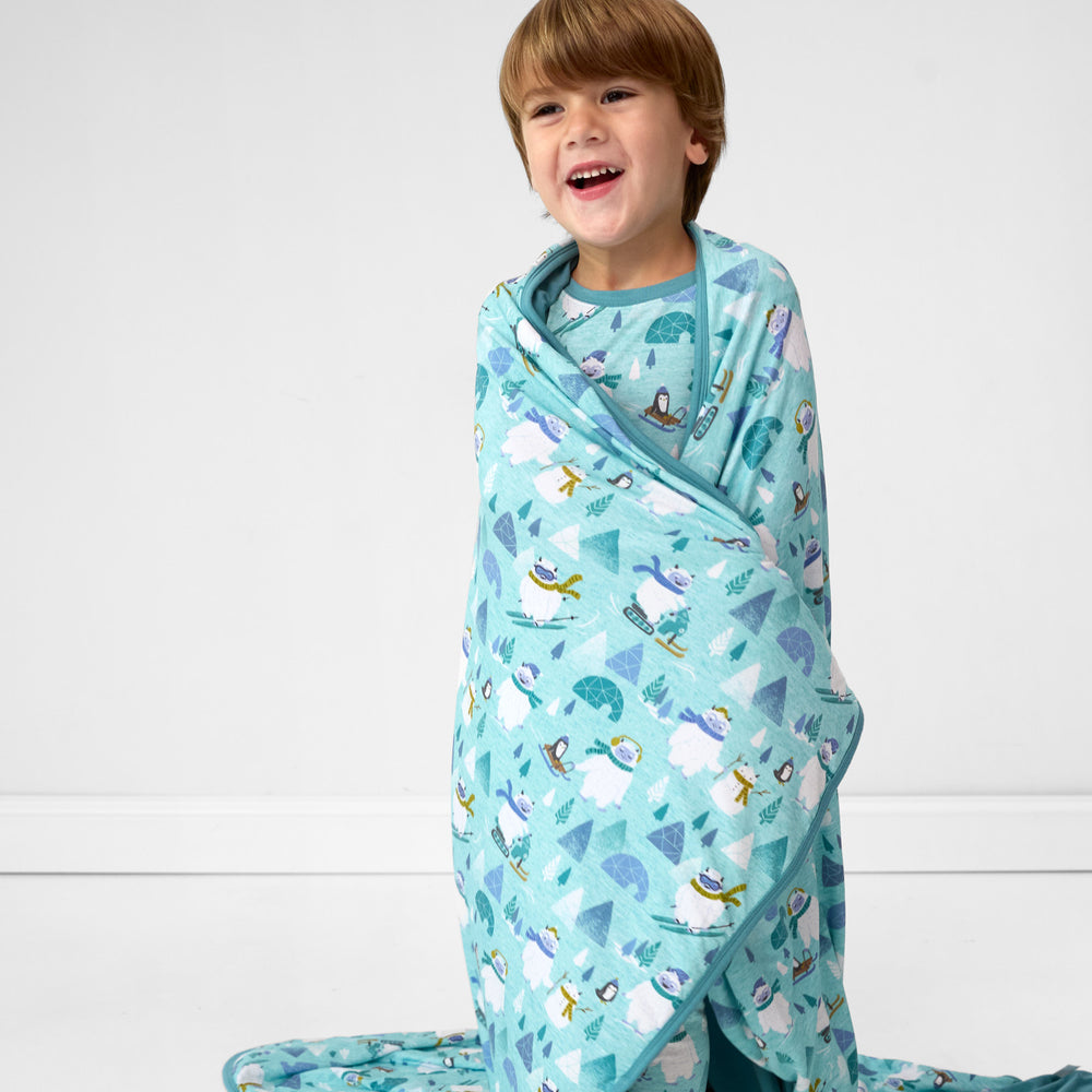 image of a child wrapped in a Yeti Snow Day cloud blanket