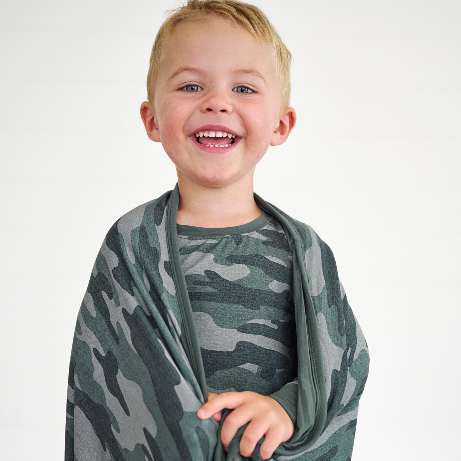 close up image of boy wrapped in the Vintage Camo Large Cloud Blanket®