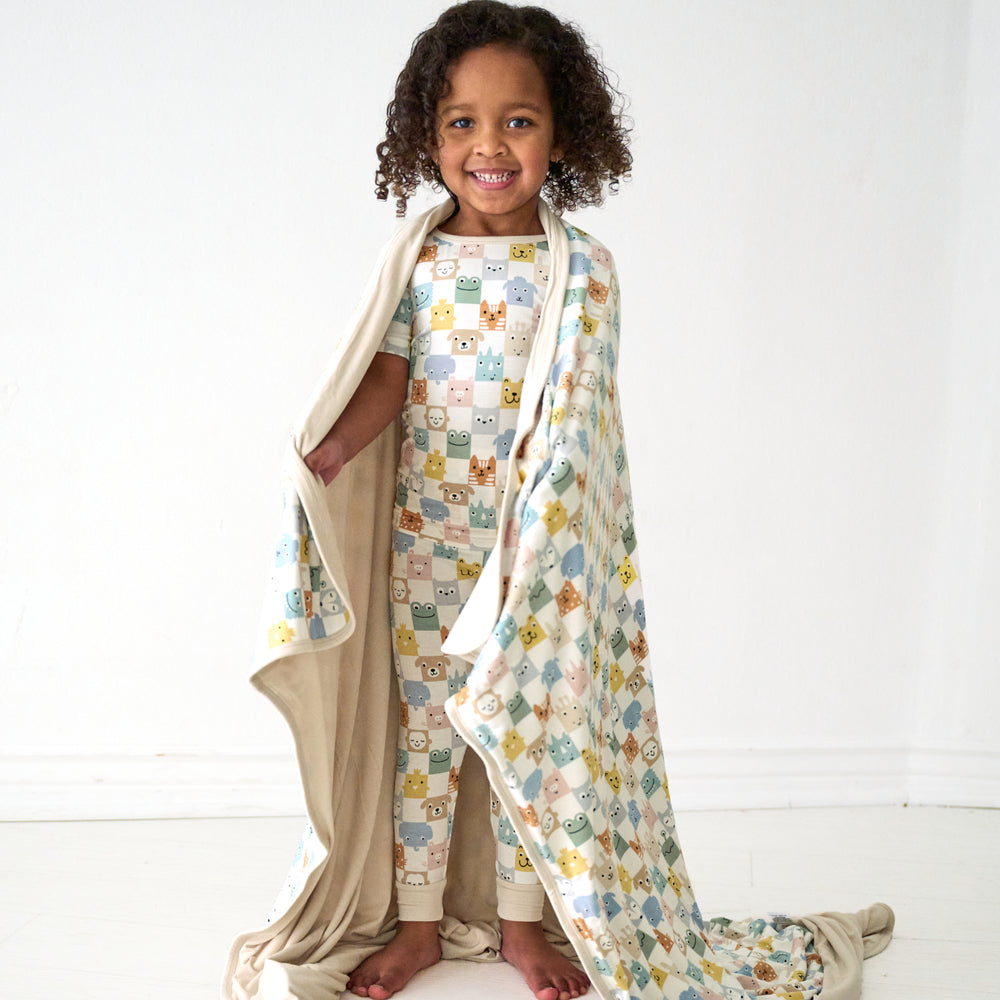 Alternate image of a child wrapped up in a Check Mates large cloud blanket and wearing matching pajamas