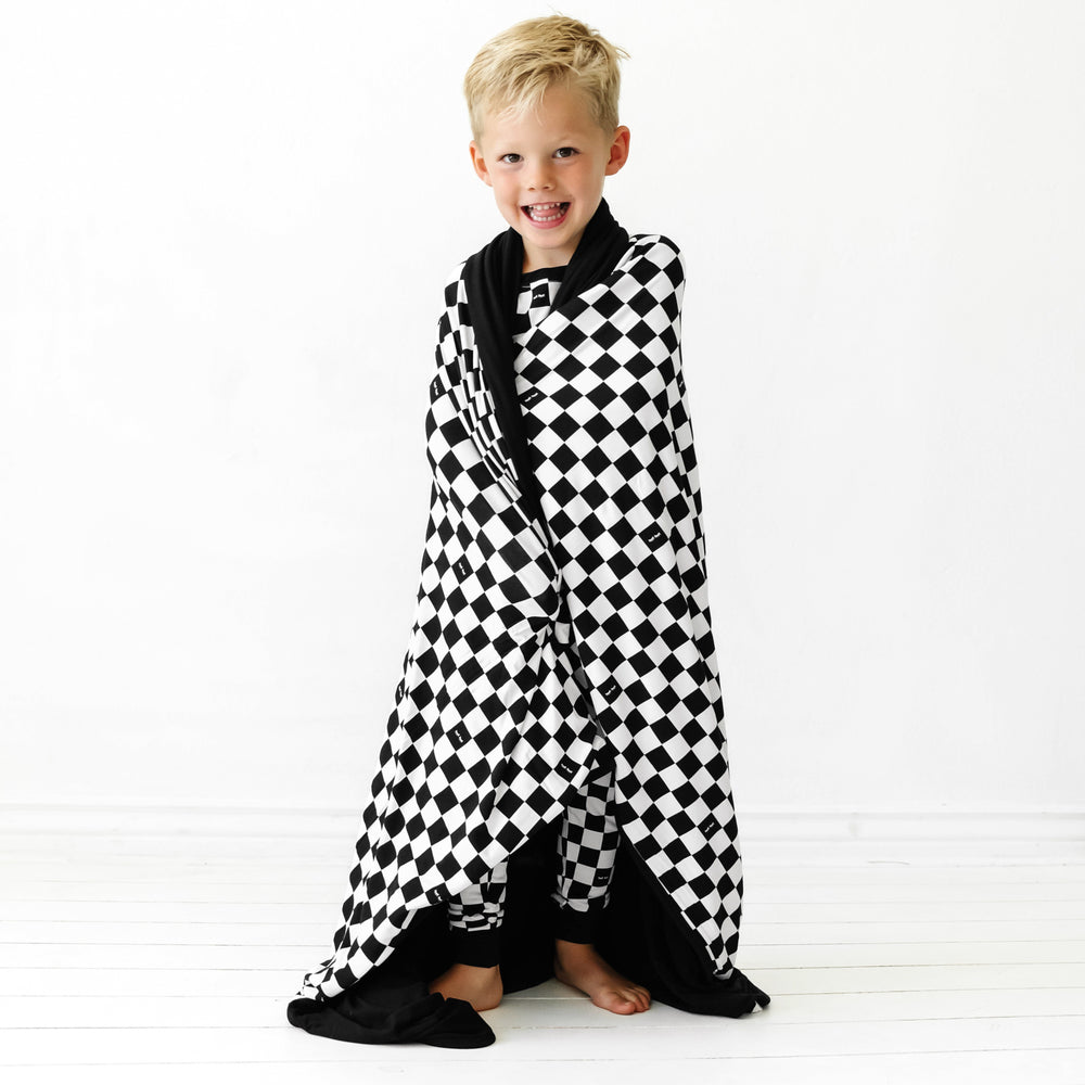 child wrapped in a Cool Checks cloud blanket