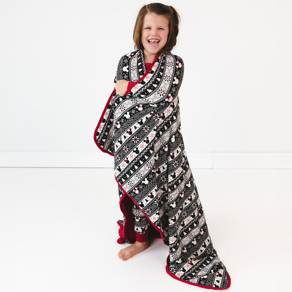 child wrapped up wearing a Mickey Fair Isle cloud blanket