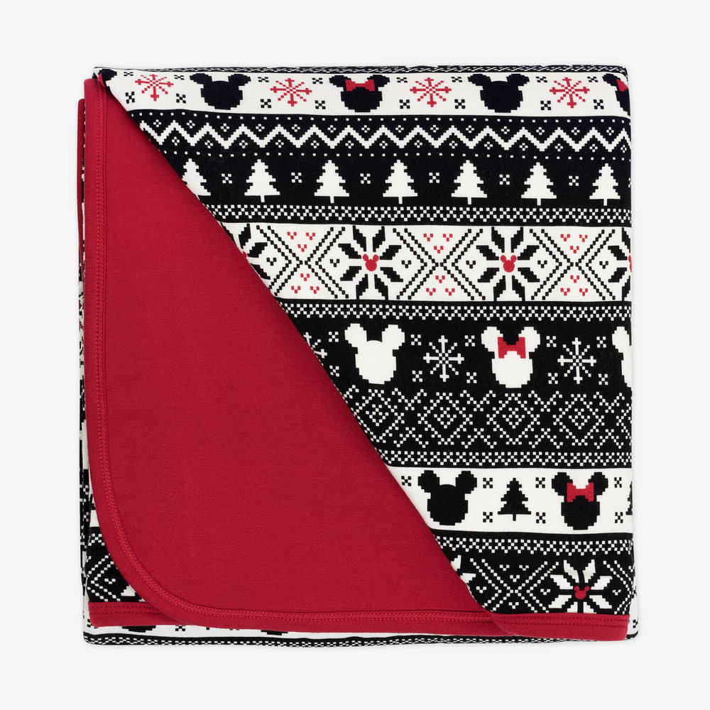 flat lay image of a Mickey Fair Isle cloud blanket showing the solid red backing