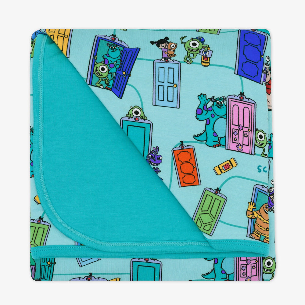 Flat lay image of the Disney Monsters, Inc. Scream Team Large Cloud Blanket® , folded