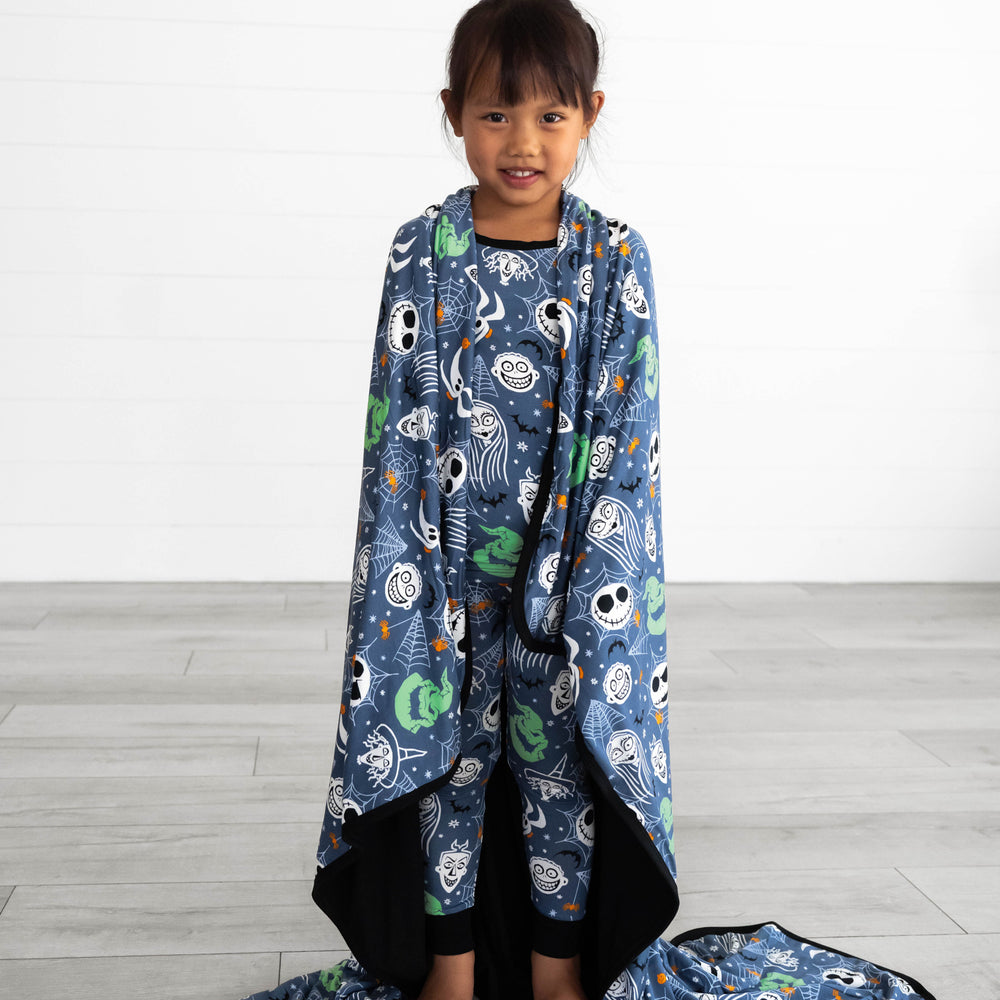 Child wrapped in the Disney Jack & Crew Large Cloud Blanket®