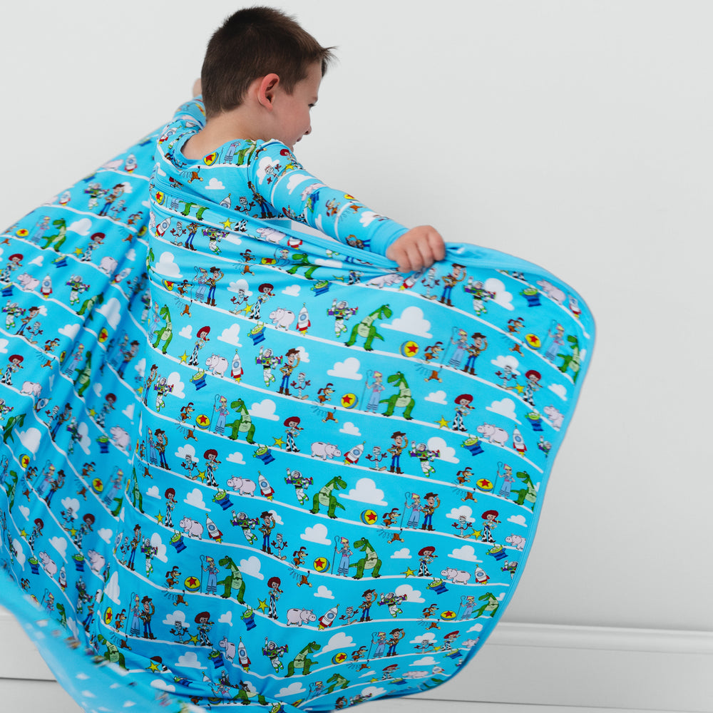 Alternate image of a child holding out a Disney Pixar Toy Story Pals large cloud blanket 