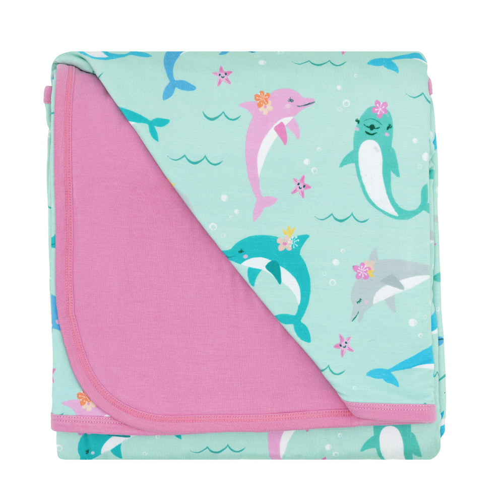 Flat lay image of a Dolphin Dance large cloud blanket