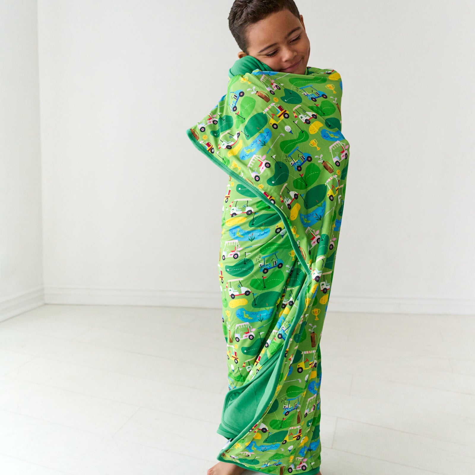 Alternate image of a child wrapped up in a Fairway Fun large cloud blanket