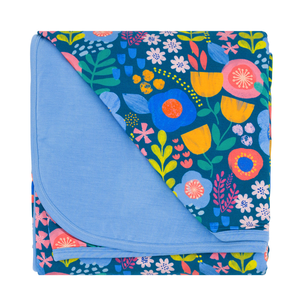 Folded flat lay image of the Folk Floral Large Cloud Blanket®