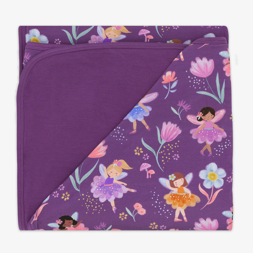 flat lay image of the Garden Fairies Fitted Crib Sheet folded