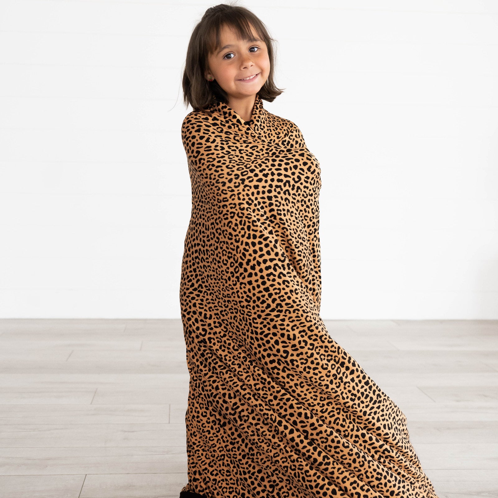 Girl wrapped in the Classic Leopard Large Cloud Blanket®