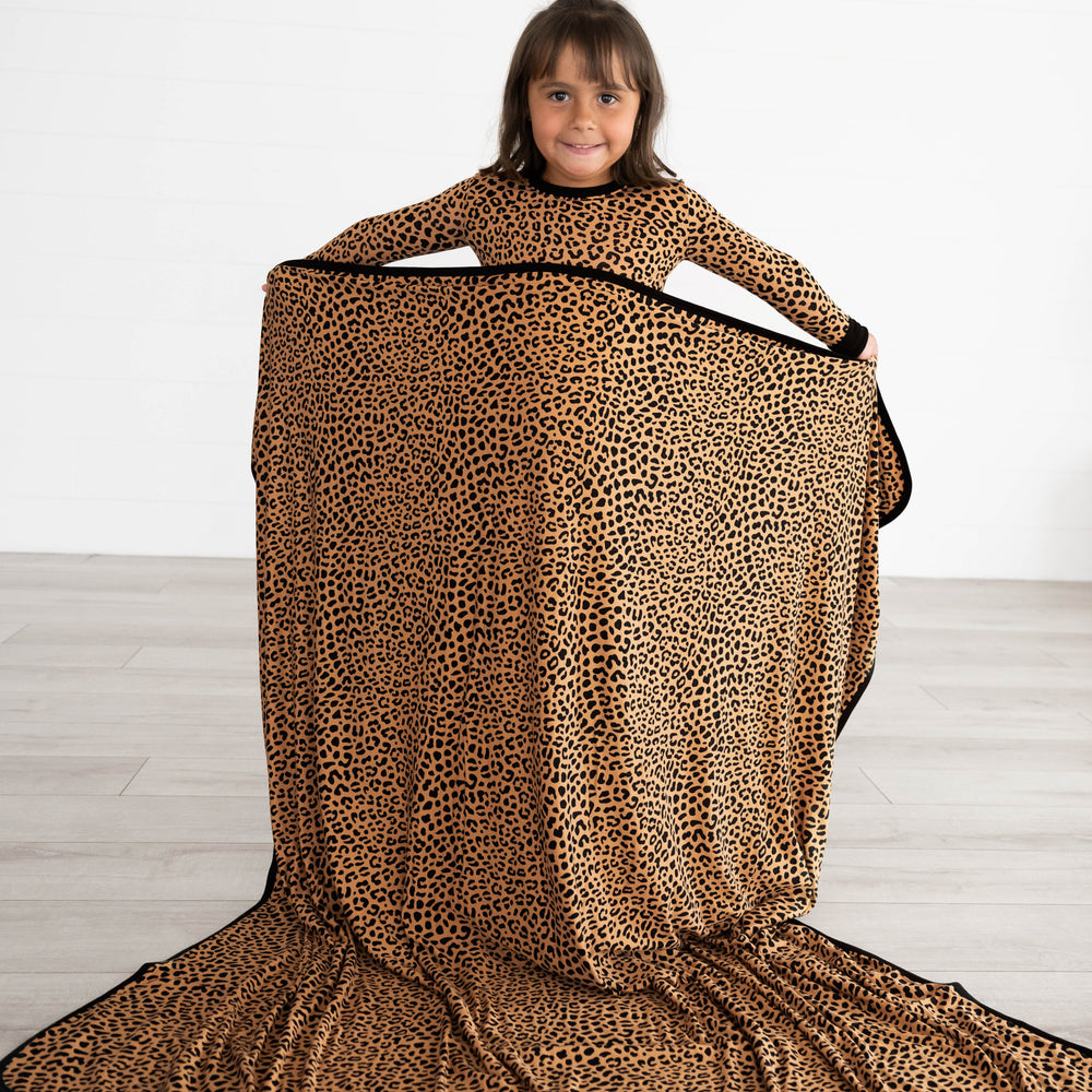 Girl holding the Classic Leopard Large Cloud Blanket®