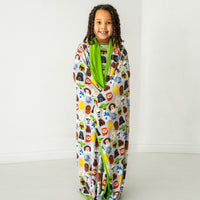 Child wrapped up in a Legends of the Galaxy large cloud blanket