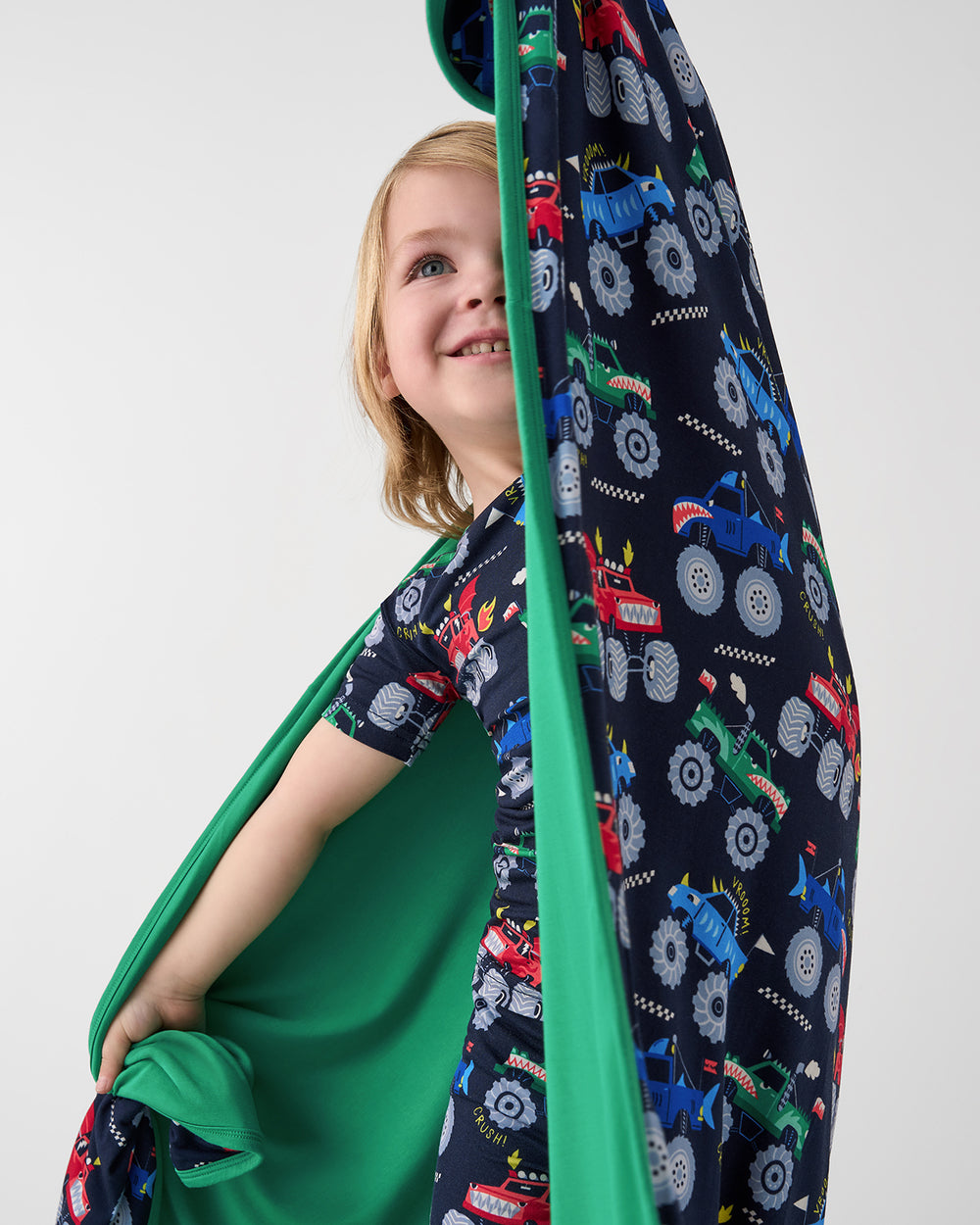 Close up of boy holding up the Monster Truck Madness Large Cloud Blanket®